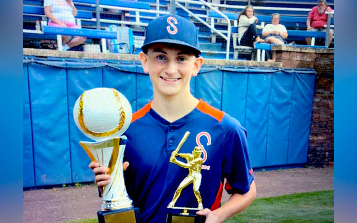 Tyler, who had a malunion fracture, with his baseball trophies.