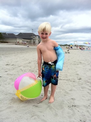 Four-year-old Tyler, wearing a cast at the beach. When his cast came off, he had a malunion. 