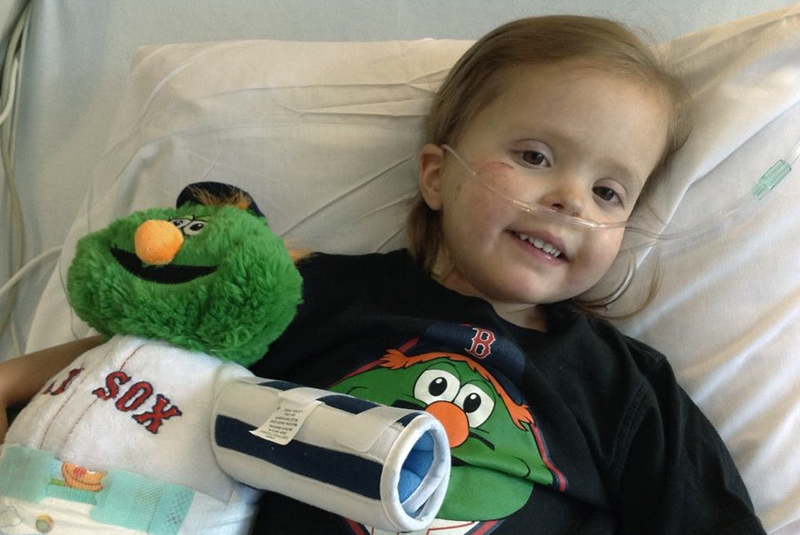 cora in bed with a wally doll as she awaited her heart transplant