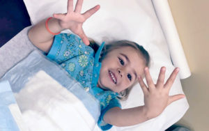 A young female patient admires her hands and fingers.