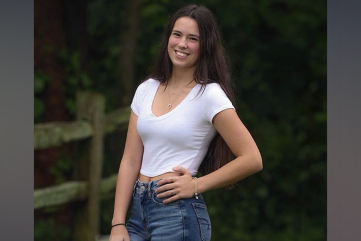 drew smiles with her hand on her hip. she is wearing jeans and a t-shirt