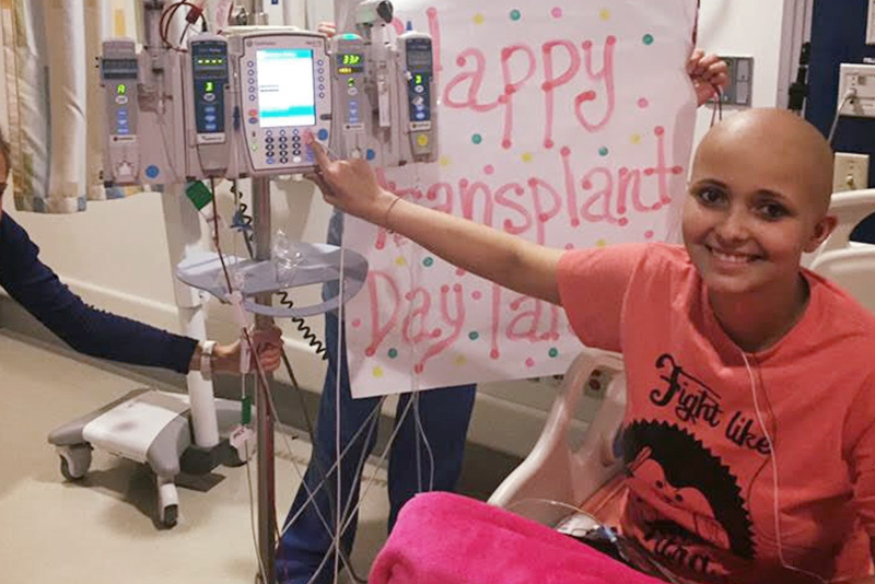 A cheerful Tara Daniels in her hospital bed, starting her stem cell transplant.