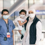 laila and her mother stand on boston children's sky bridge with Dr. Lissette Jimenez