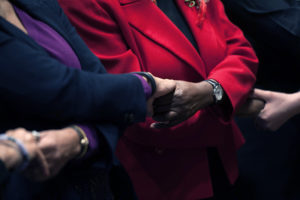 People join hands at an event celebrating civil rights leader Martin Luther King, Jr.
