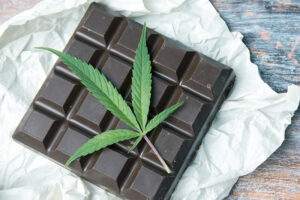 A chocolate bar with a marijuana leaf on top of it.