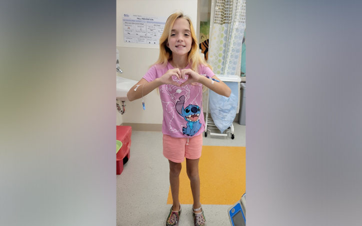 echo, who has midaortic syndrome, holds her hands together in the shape of a heart