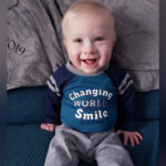 Infant Liam Allis offers the camera a big smile.