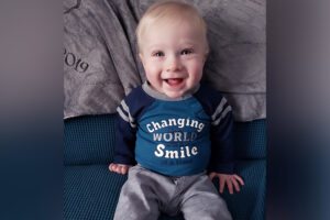 Infant Liam Allis offers the camera a big smile.