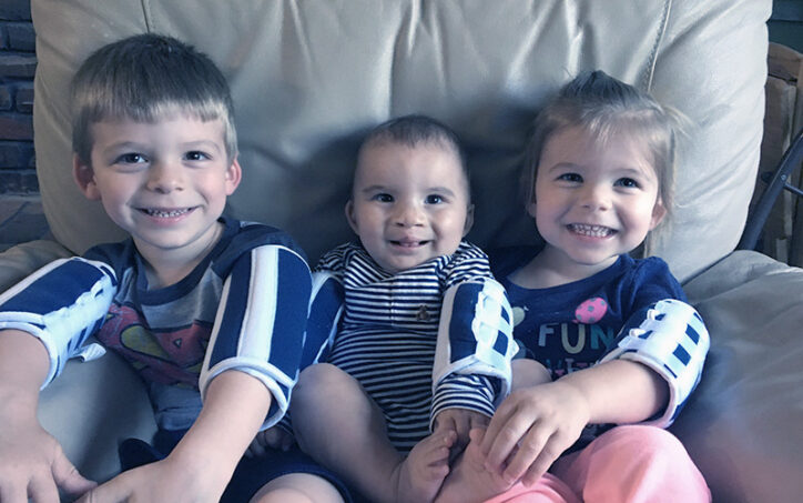 Jackson, Logan, and Adalyn Hatfield sit on a couch in a family photo taken in August 2019.