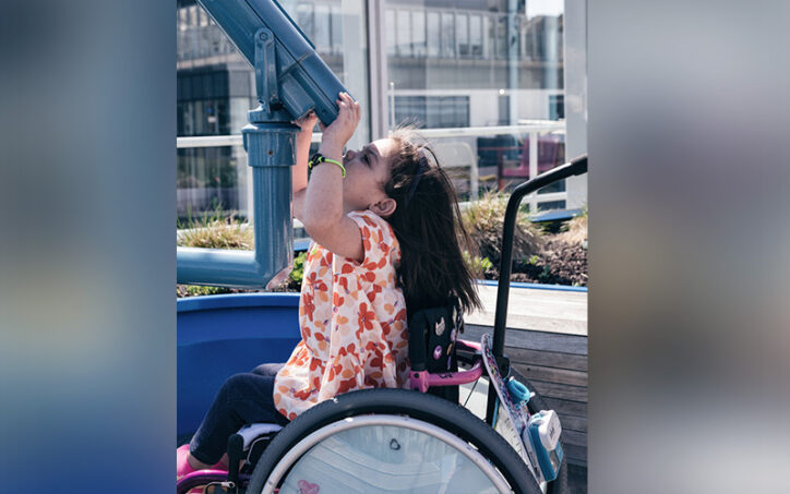 Kira, who had a kidney transplant, looks up through the telescope on Boston Children's roof deck. 