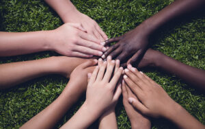 children's hands of different skin tones placed together