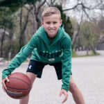 Drew, who had Legg-Calve Perthes disease, dribbles a basketball