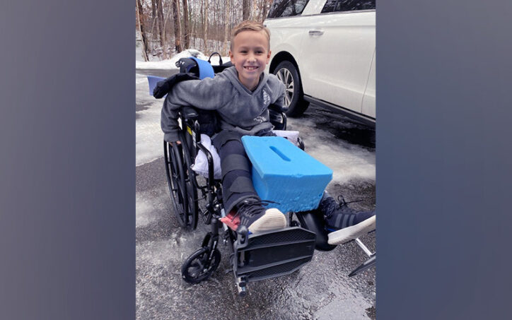 Drew in a wheelchair with the foam wedge that held his hip in place after surgery for Legg-Calve Perthes disease. 
