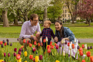 micah plays with his parents in the Boston Public Garden