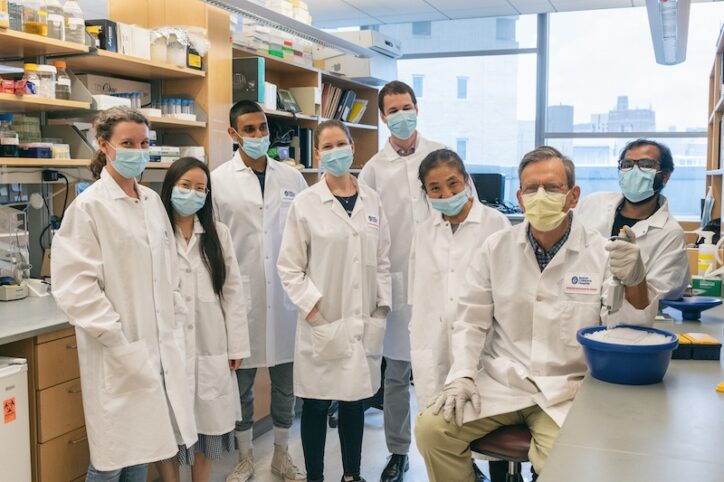 A group of scientists wearing masks, including Springer, in the lab