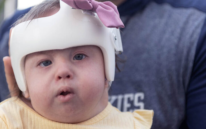 Brooklyn Haggan sits on her father's lap during a visit to Boston Children's Hospital.