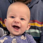 Myles as a baby, smiling at the camera