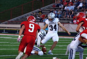 Davidson, who had an AVM, kicks a football