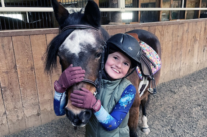 Georgia cuddling with her pony, unfazed by sJIA