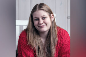 Paige, who had a nerve block to manage post-surgical pain, at home smiling.