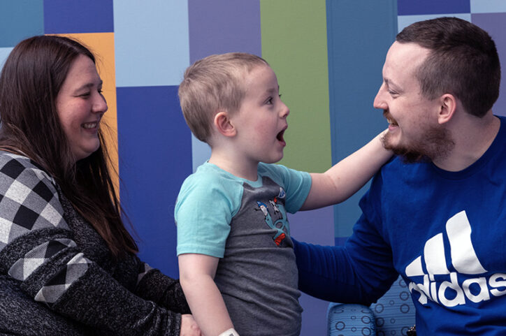Conner, the first CCALD patient to receive Skysona outside a clinical trial, laughs with his mom and dad.