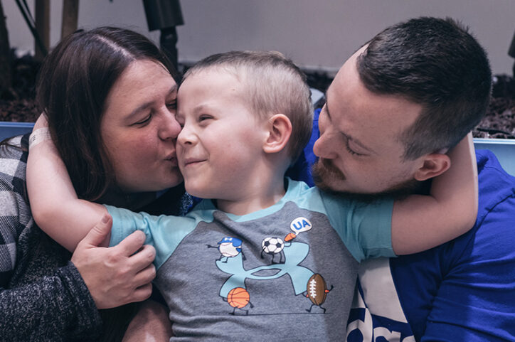 Conner, the first CCALD patient to receive Skysona outside a clinical trial, hugs his parents.