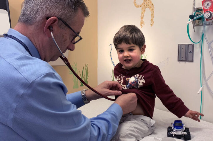 A cardiologist places a stethoscope on Easton's chest.