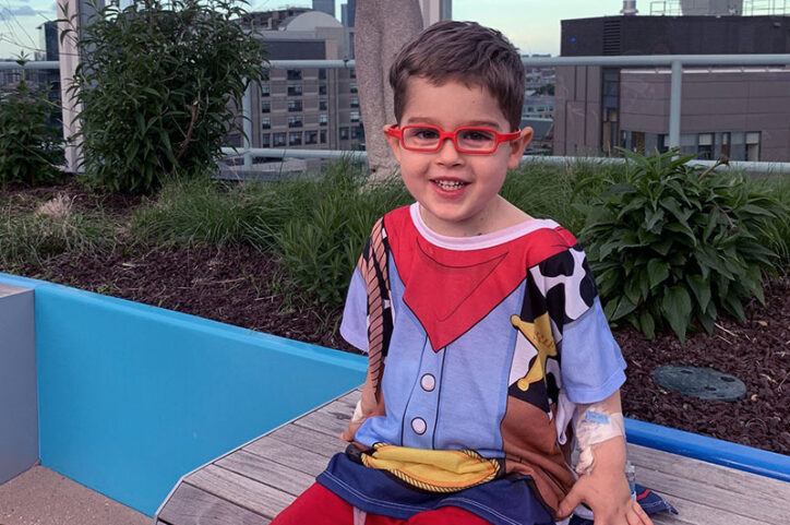Wearing a Woody the Sheriff T-shirt, Easton relaxes on a bench on the rooftop of Boston Children's Hospital. 
