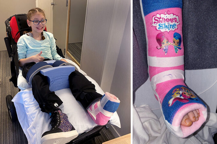 Ashlyn, who has cerebral palsy, in a wheelchair after hip surgery, looking at Shimmer and Shine cartoons on her cast. 