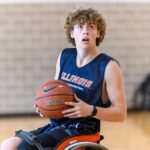 Grant ready to shoot a basketball from his wheelchair.