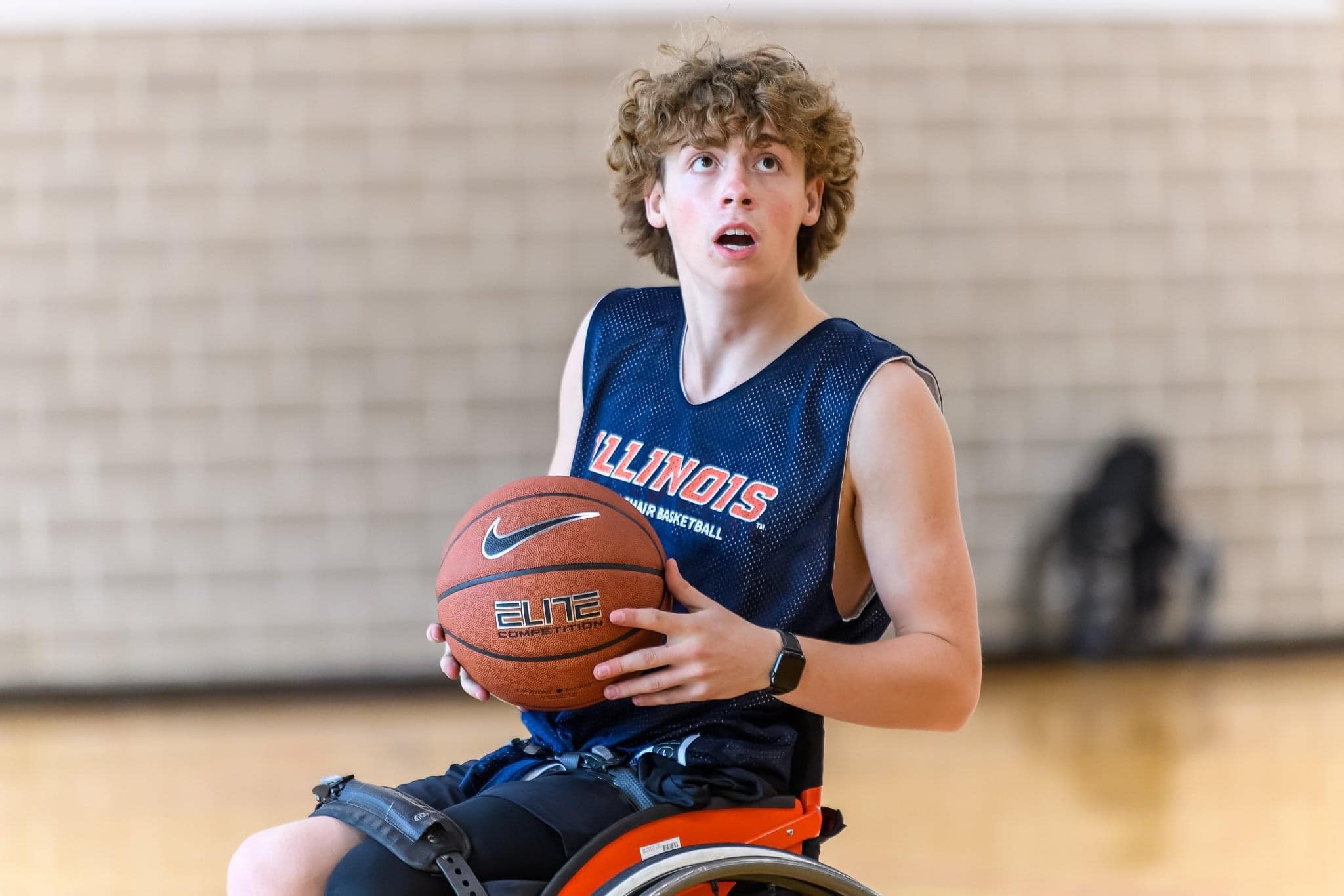Grant ready to shoot a basketball from his wheelchair.