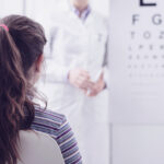 A girl taking an eye exam at a doctor's office
