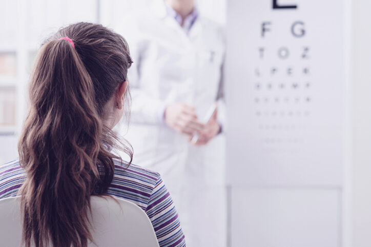 A girl taking an eye exam at a doctor's office