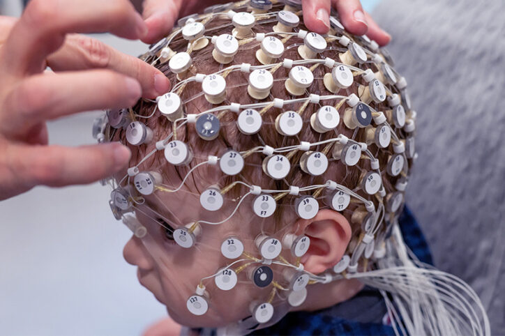 A child wearing a cap with EEG electrodes.