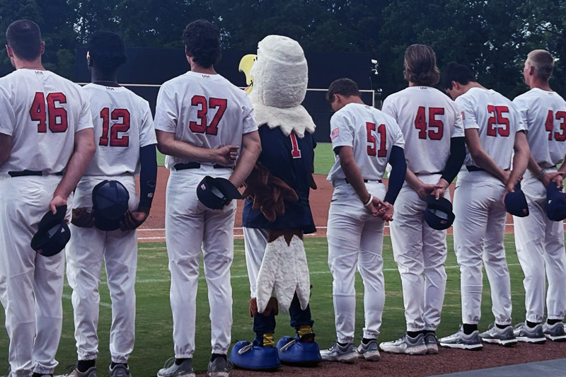 Irvin in an eagle mascot costume, on the first-base line with the minor league baseball team he represents.