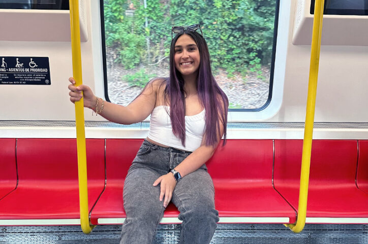 Dianna sits in a subway car.
