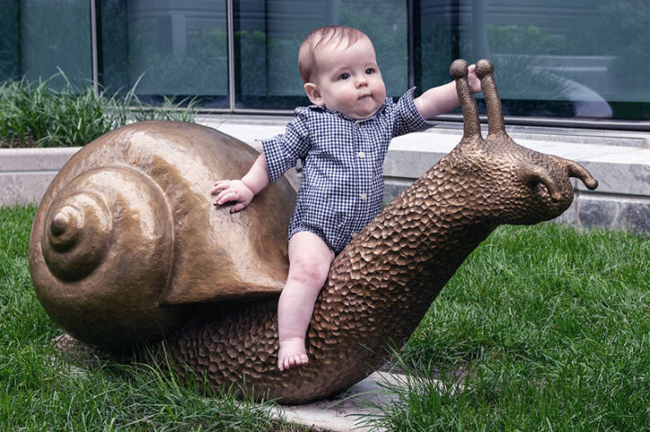 Eoin sits on a snail sculpture on the Hale Building rooftop garden
