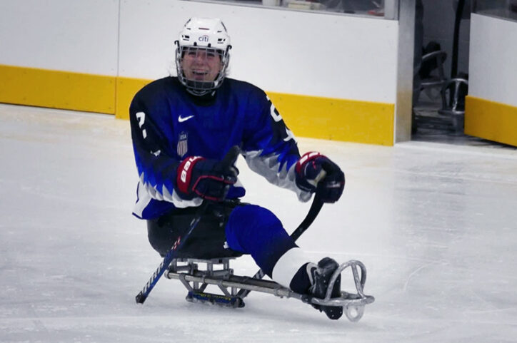 A smiling Ladlie on the ice with her prosthetic leg.