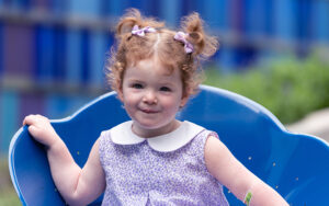 A child sitting in a blue chair.