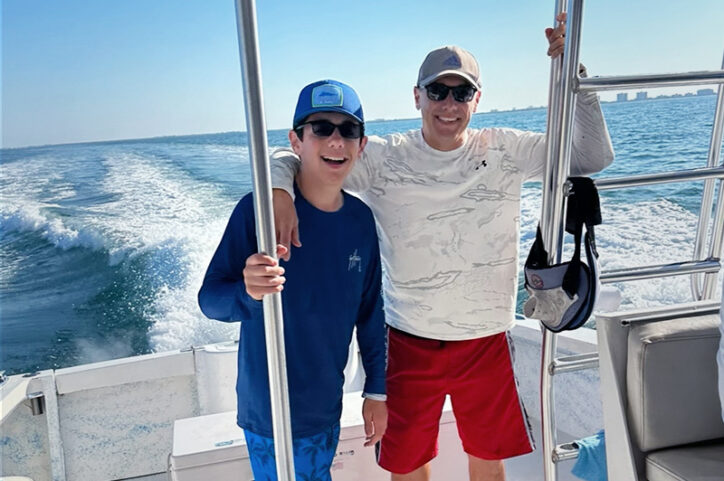 Peyton on a fishing boat with his dad