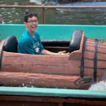 peyton rides in a log flume ride at an amusement park