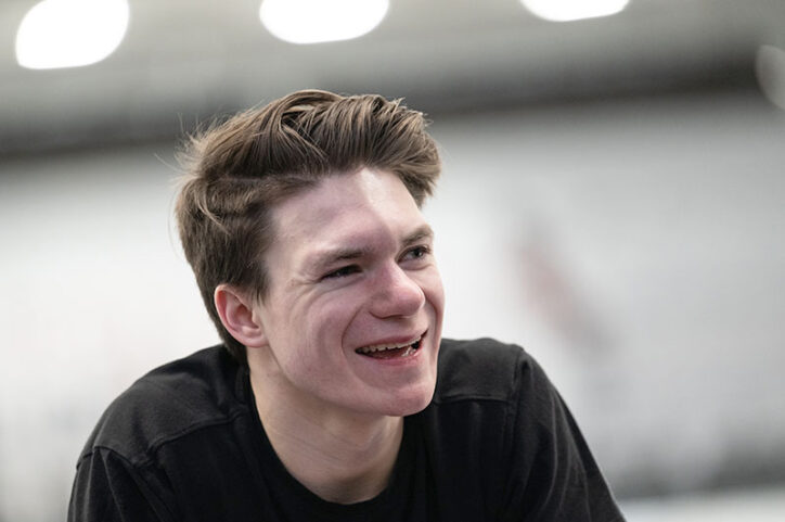 Figure skater Max smiling after a practice at the Boston Skating Club.