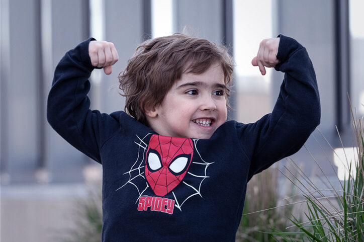Lucas flexes his muscles in a show of confidence after treatment for Duchenne muscular dystrophy.