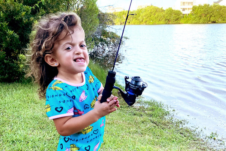 A child holding a fishing pole.
