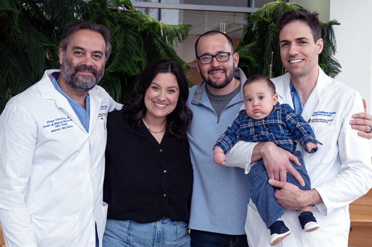 Alireza Shamshirsaz, MD, and Eyal Krispin, MD pose with nine-month-old Jace and his mother and father.