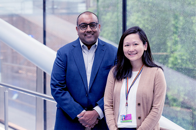 Amar Majmundar and Nina Mann on a bridge connecting Boston Children's Hospital with a parking garage.