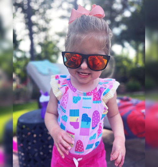 2-year old Isabelle in sunglasses.