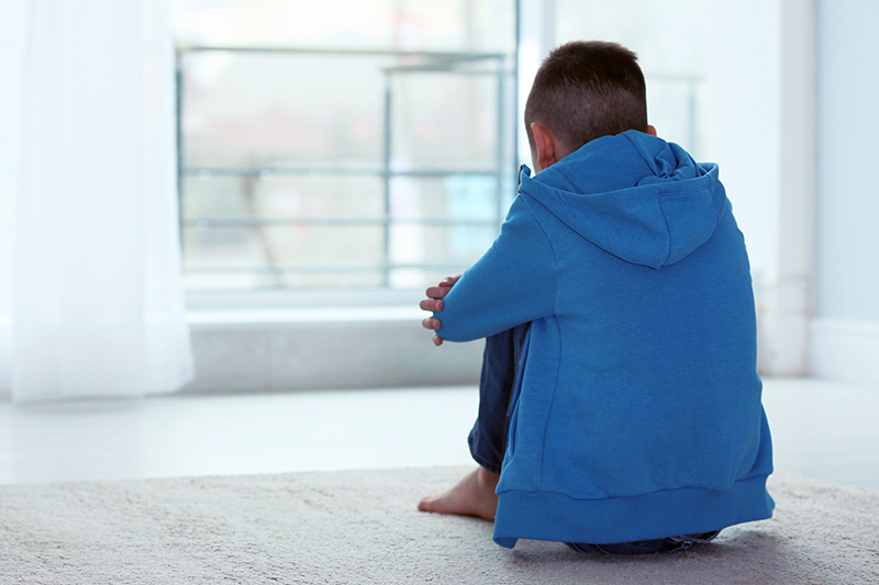 A boy gazing out a window