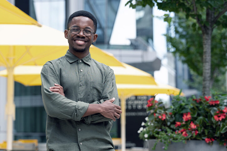 A smiling Olumide Fagboyegun outside his lab building.