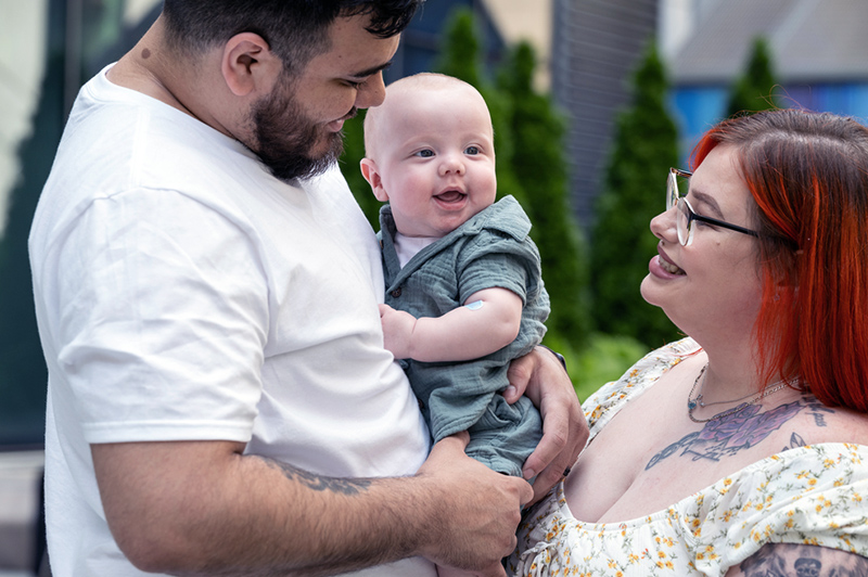 Angel and Jennifer hold baby Issac.